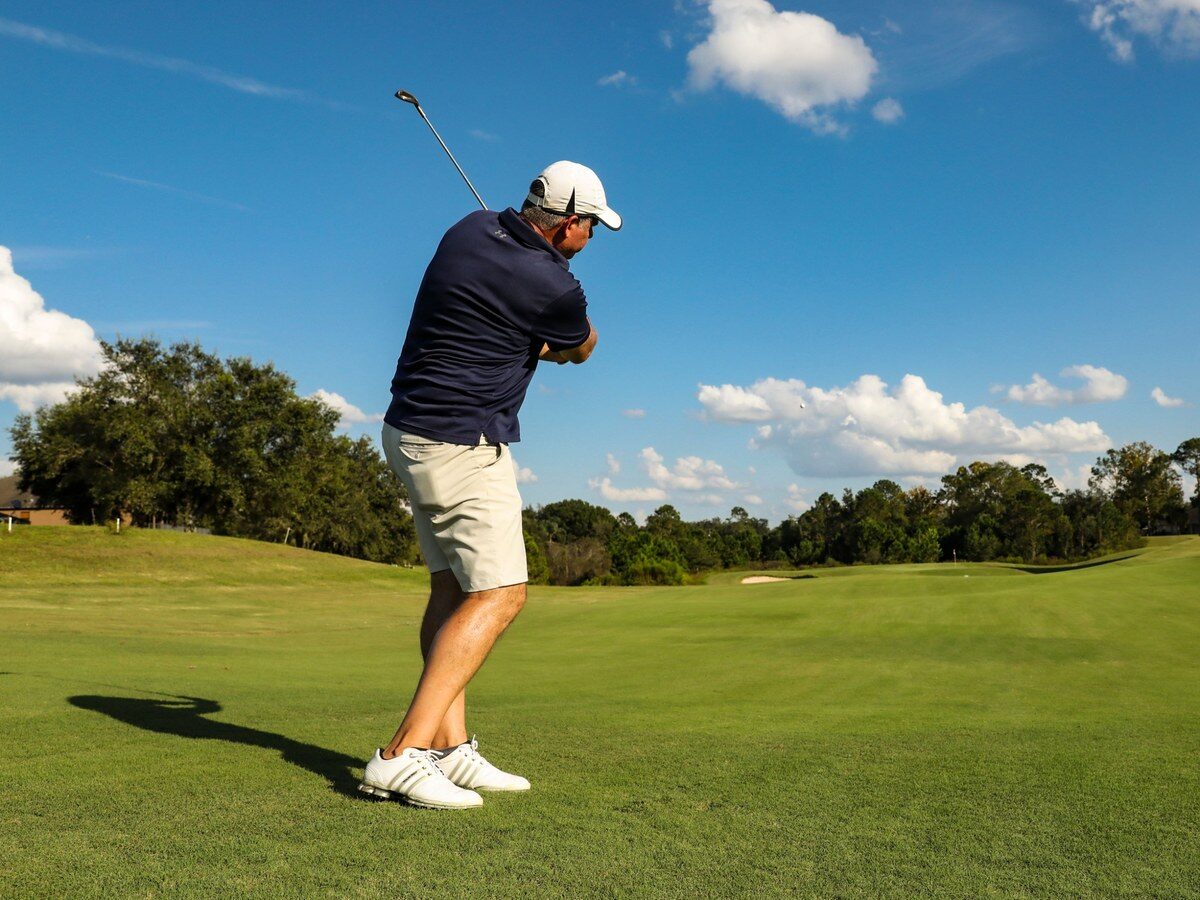 Golfer swinging on the fairway